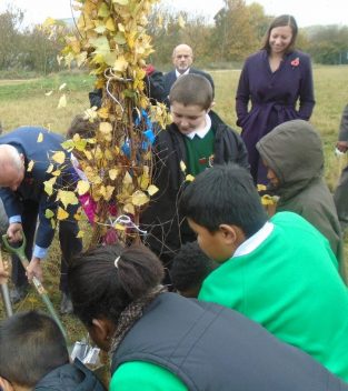 Students at Willow Brook planting a tree from the Woodland Trust