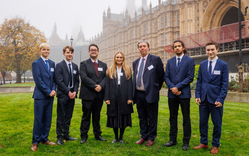 Students from tomorrow's young scientists programme at a parliamentary mock select committee standing outside the parliament