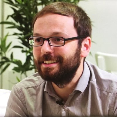 Photograph of Thomas Rhys Evans , a scientist in the fields of Occupational Psychology and Open Science. They are smiling and look off to the side of the camera.