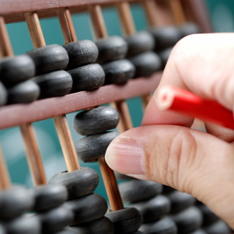 Calculate vintage wood abacus in classroom with blackboard background