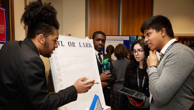 A Partnership Grant student explaining their project to other students of the conference.