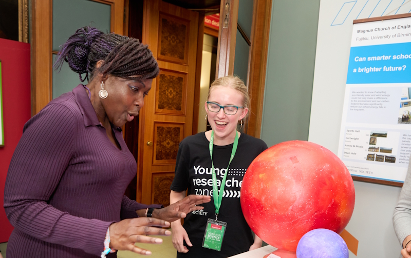 A Young Researcher Zone school exhibitor explaining their research project to Dr Maggie Aderin-Pocock.