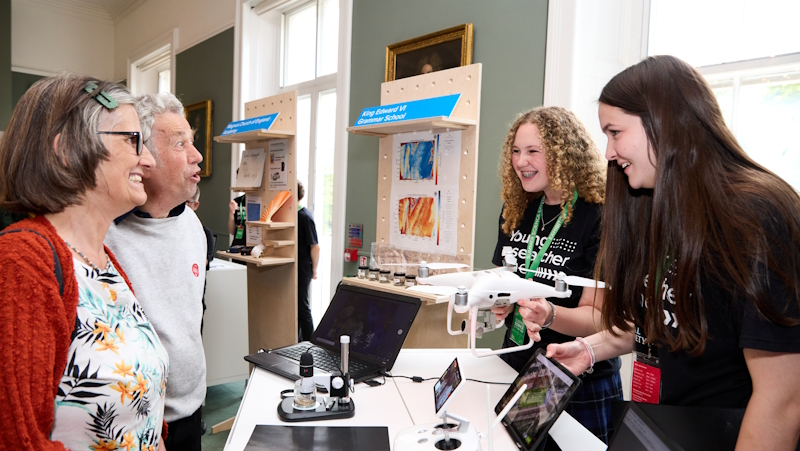 Young Researcher Zone student exhibitors explaining their research project to visitors of the Summer Science Exhibition.