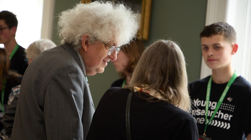 Professor Martyn Poliakoff attending one of the Young Researcher Zone stands.