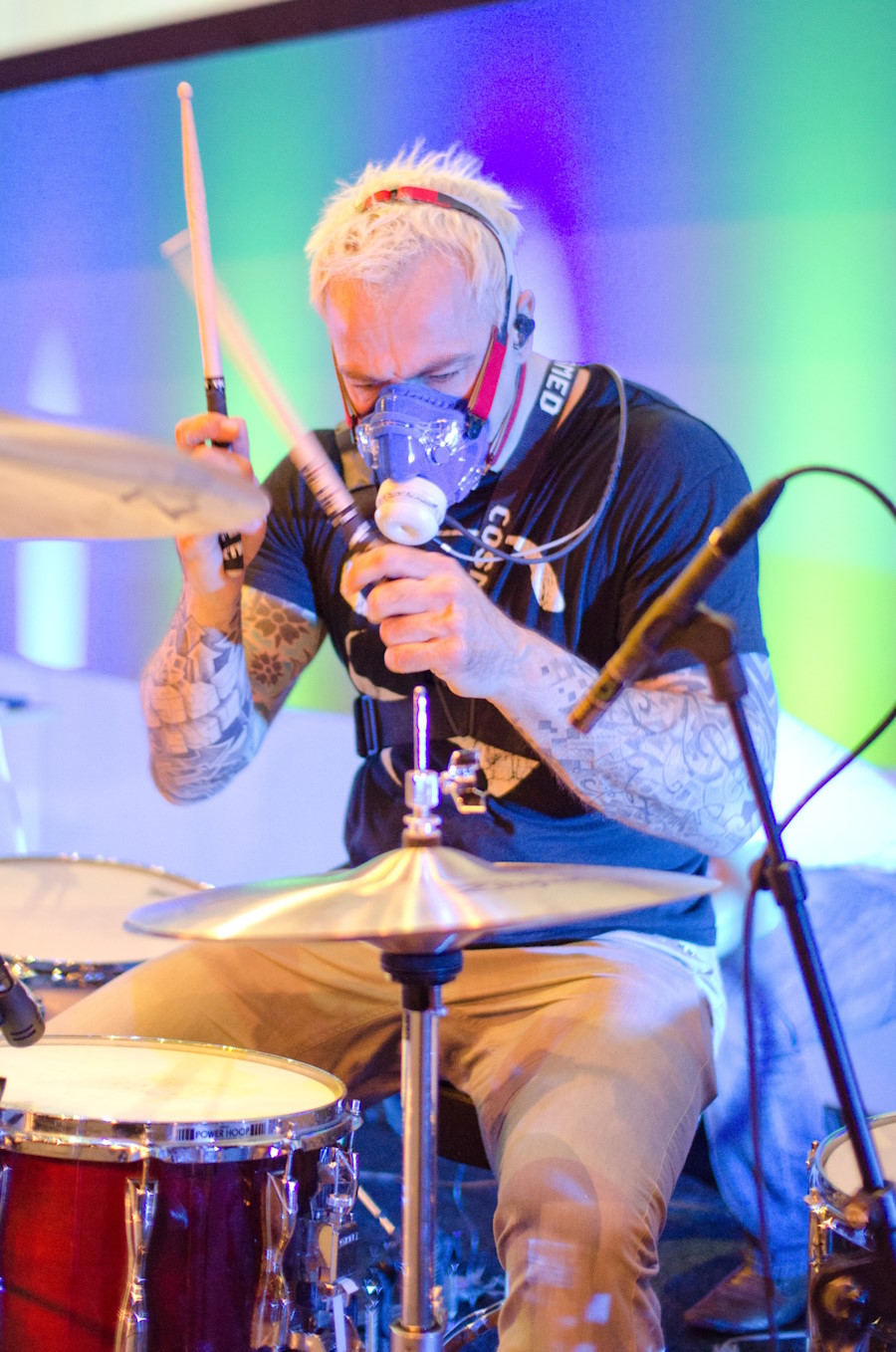 Image of a man playing a drumkit while attached to medical monitors