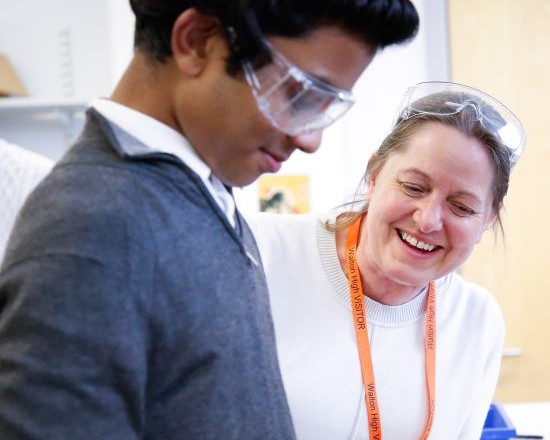 Teacher and student in science goggles