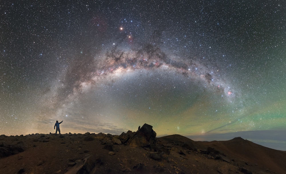 The Milky Way over a rocky landscape.