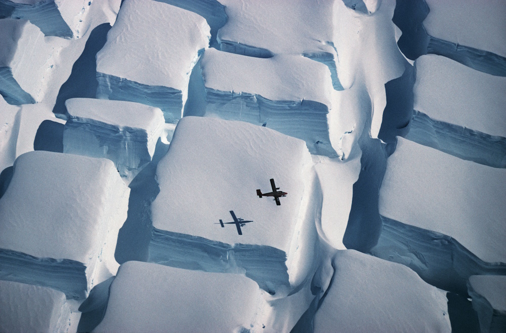 A plane flying over ice.