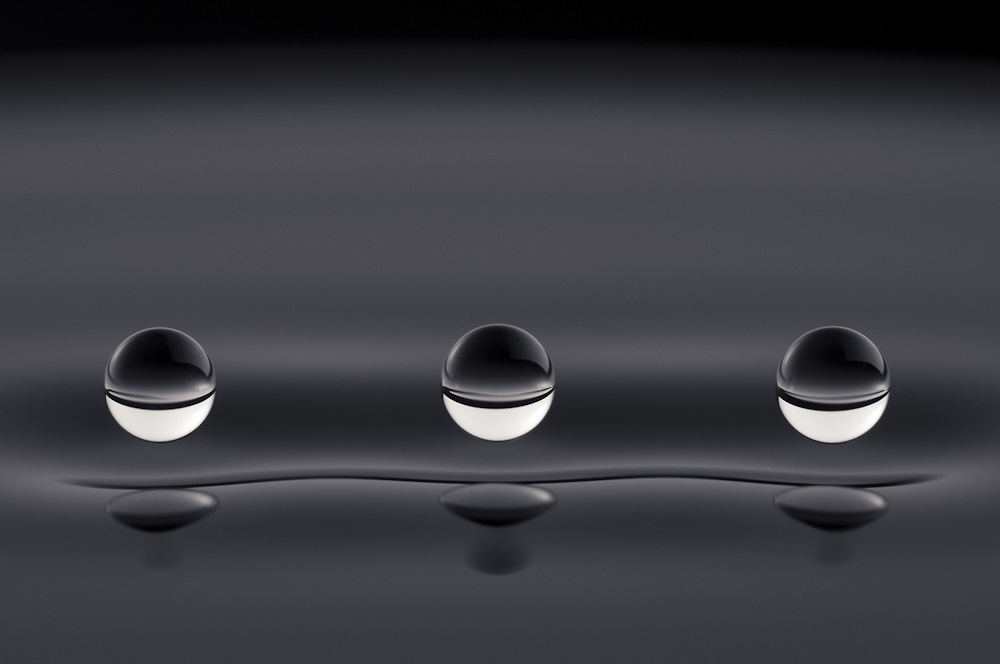 Silicone oil droplets bouncing above a vibrating pool of silicone oil.
