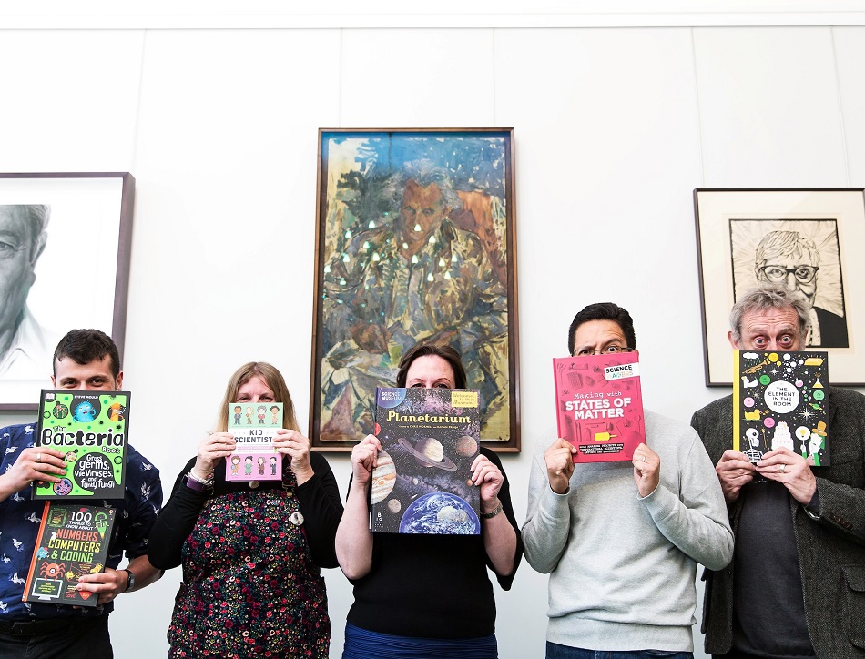 Five judges of the 2019 Royal Society Young People's Book Prize holding six of their shortlist selections