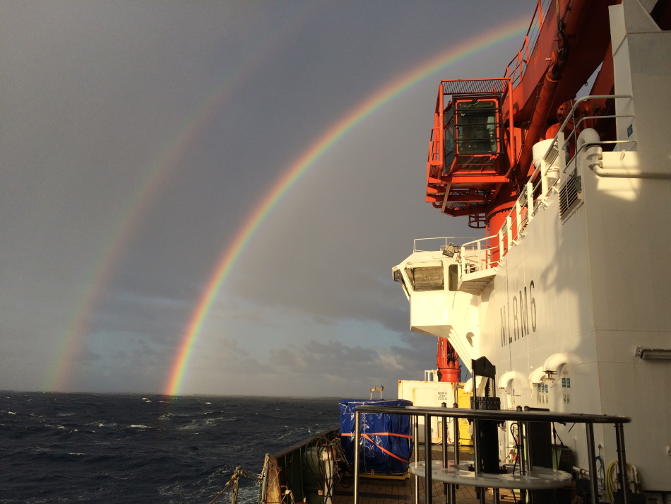 A research vessel in the Atlantic beneath a rainbow