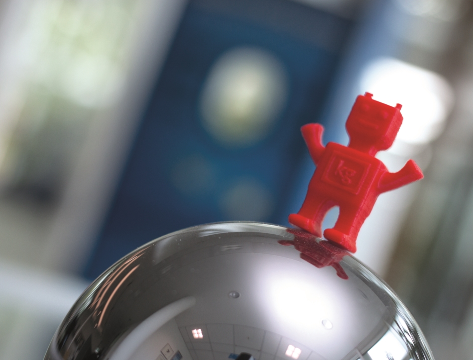 The kilogram SI-bot perched on top of the silicon sphere. Credit: NPL