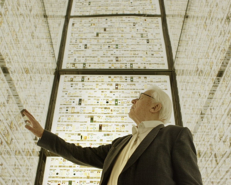 David Attenborough in brightly lit room full of thin section samples