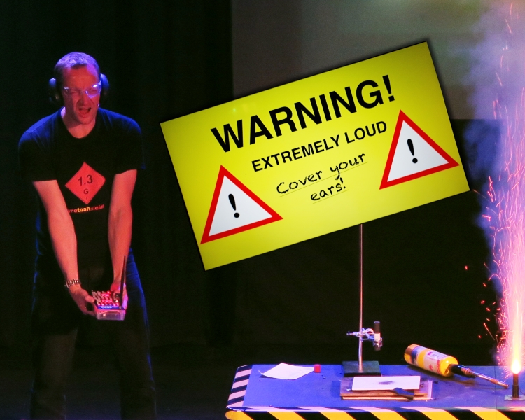 A man causing an explosion indoors with a 'warning' sign in the background