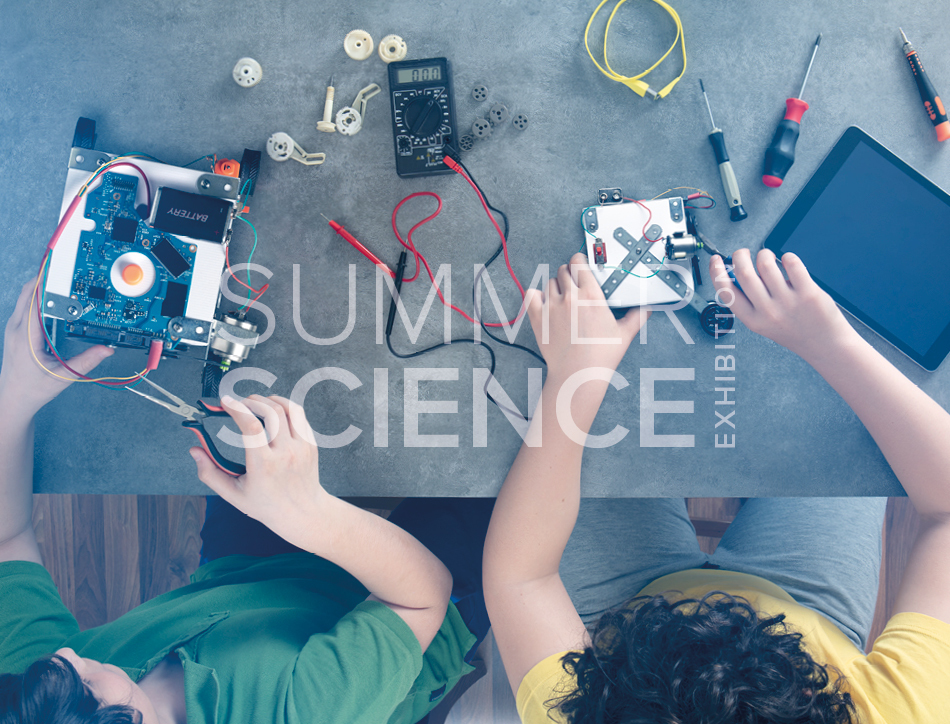 Summer Science Exhibition: two children building table-top robots
