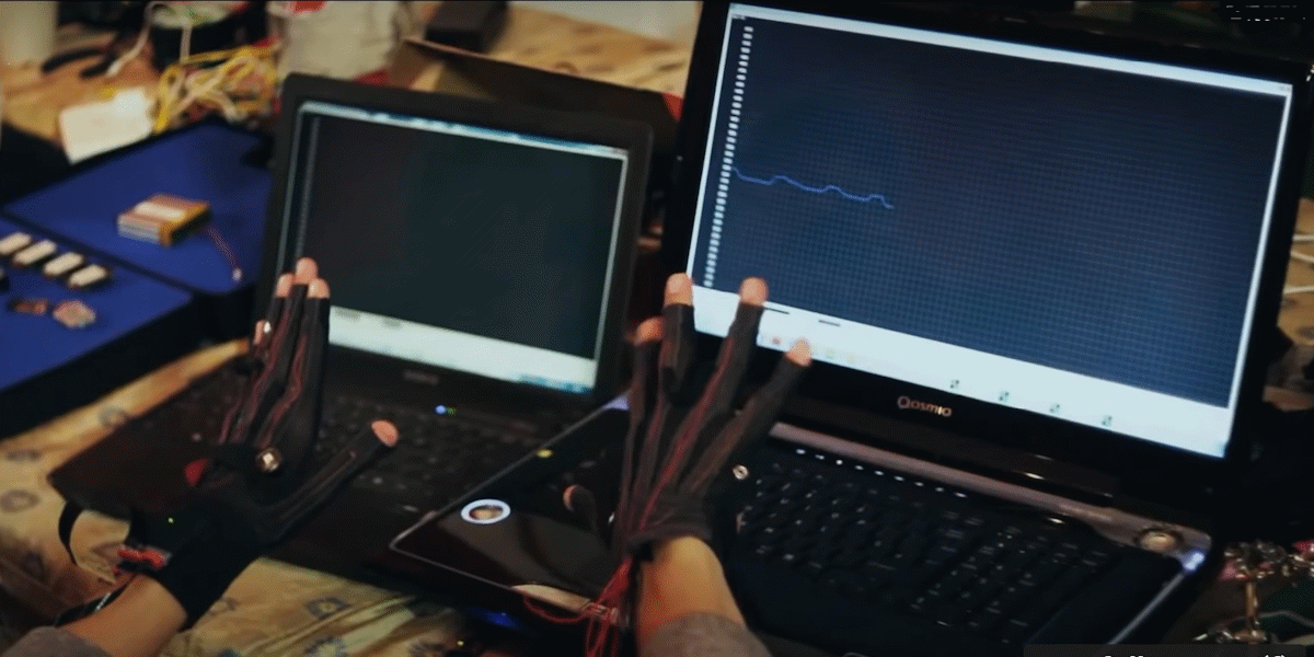 MI.MU gloves in front of two laptops with sound generated from movement